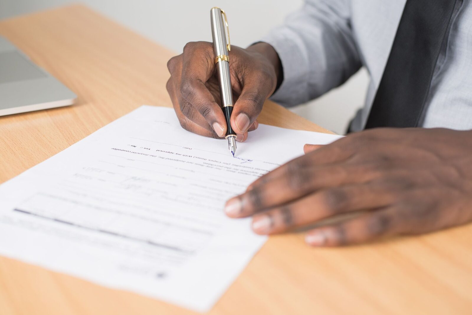 Hands signing a document with a fountain pen, standing in for the close of Altay Therapeutics' Series A