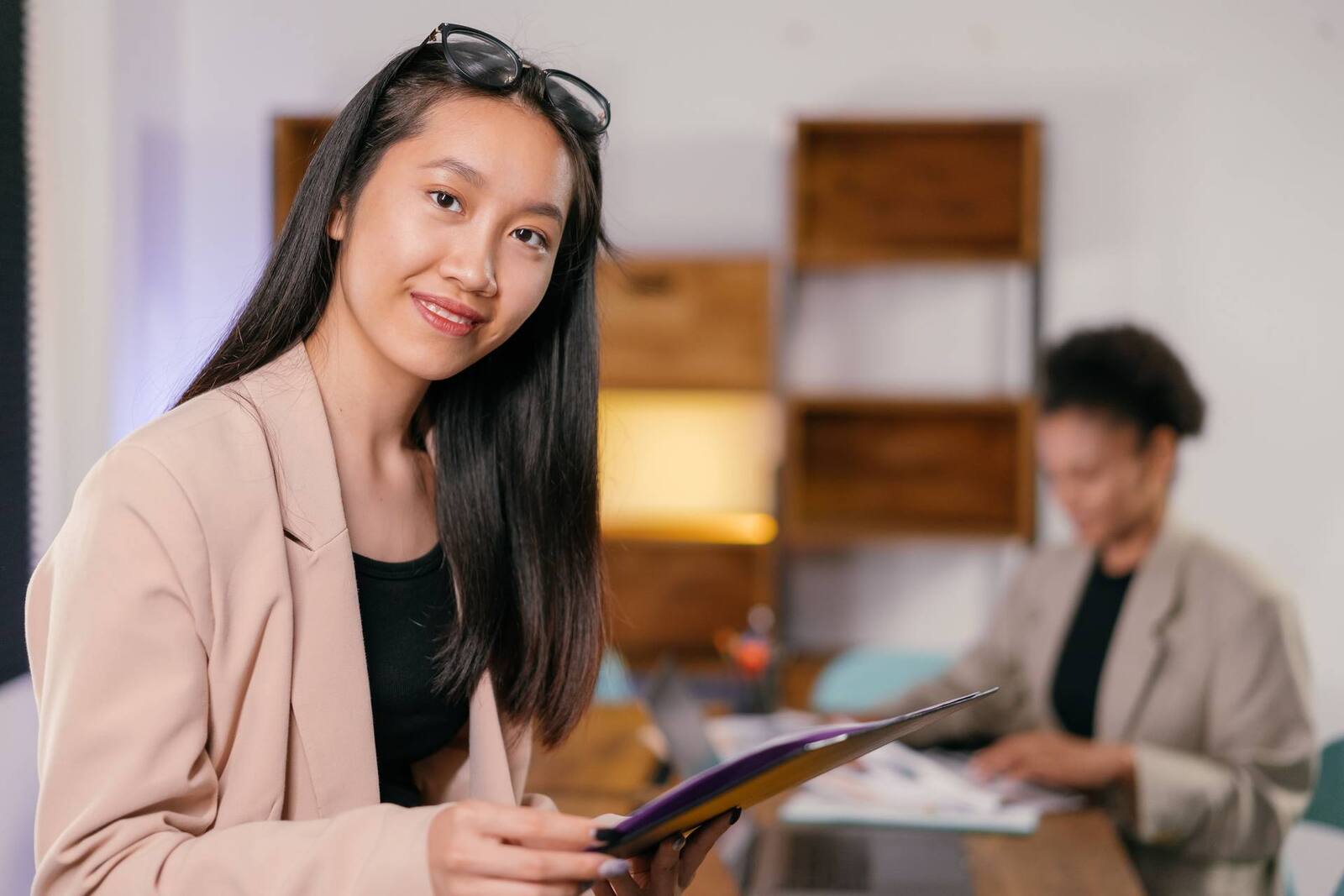A young professional holding a folder in a bright office, a generic stand-in for a BioCryst commercial or regulatory affairs team