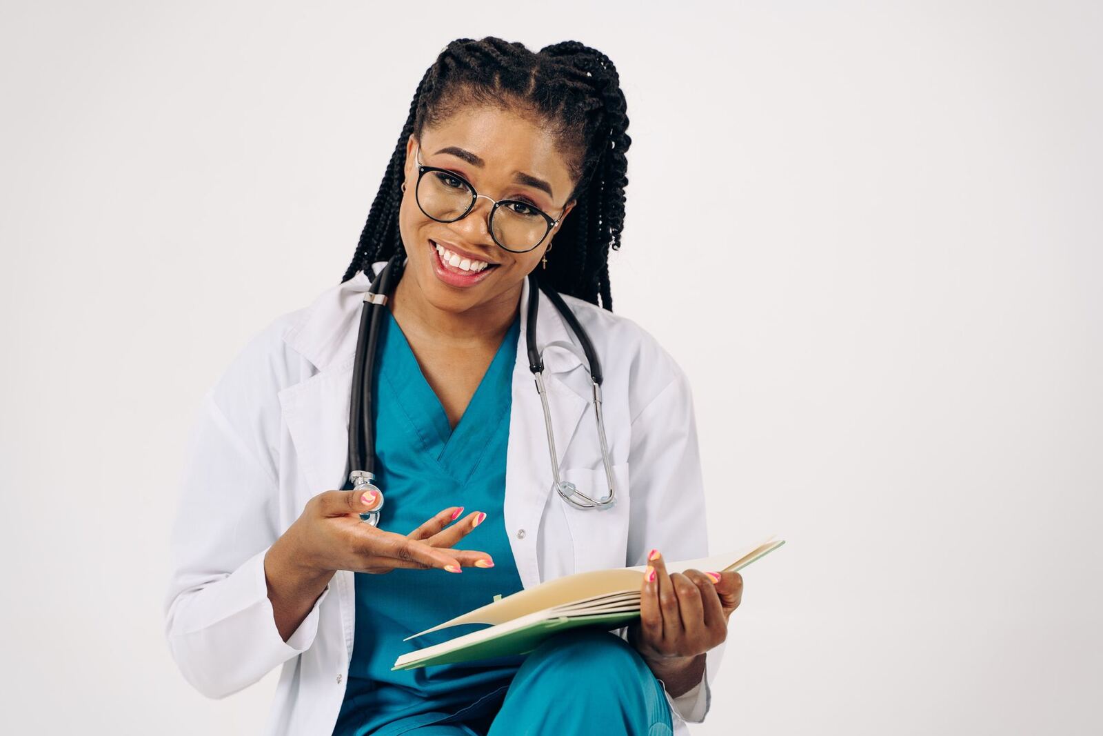 A physician in a white coat reviews a folder while smiling