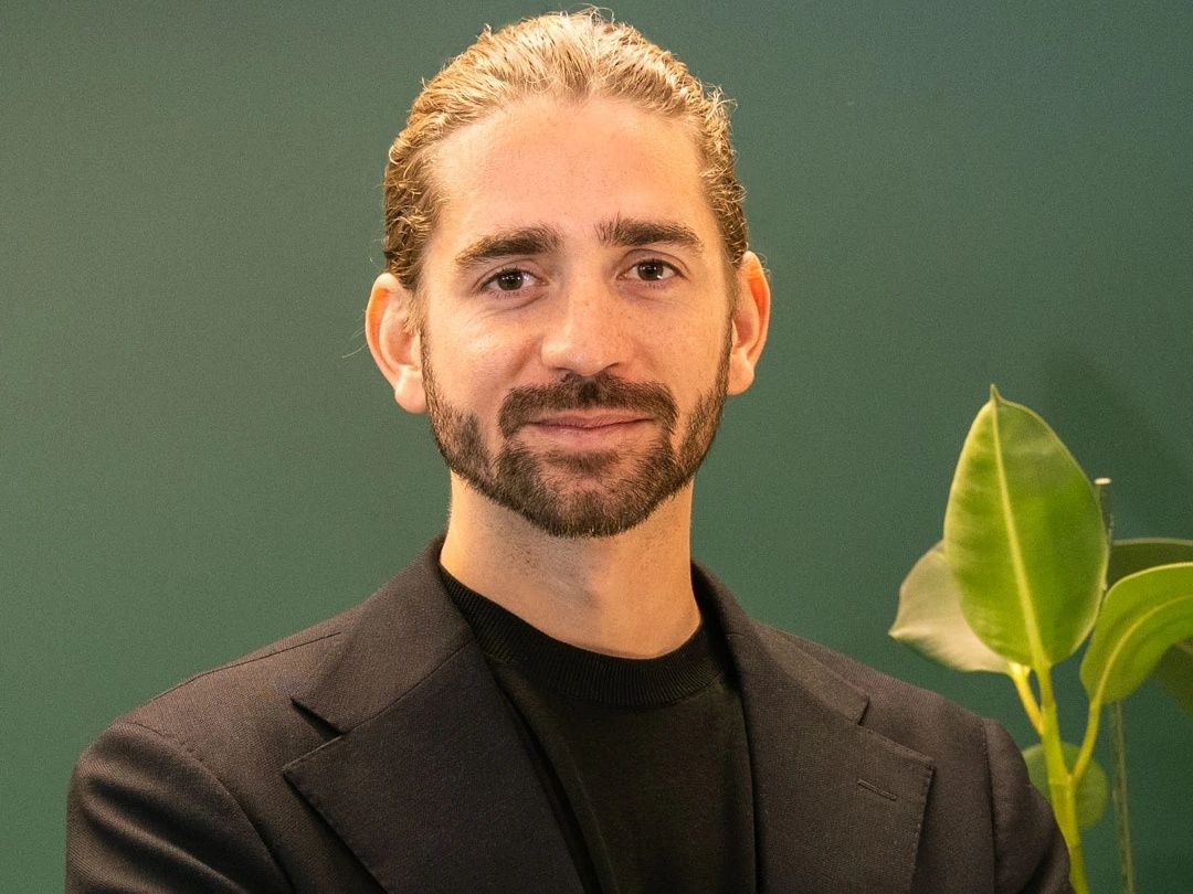 Juan Martinez, Chief Executive Officer of Curaleaf International, in a dark jacket against a green wall