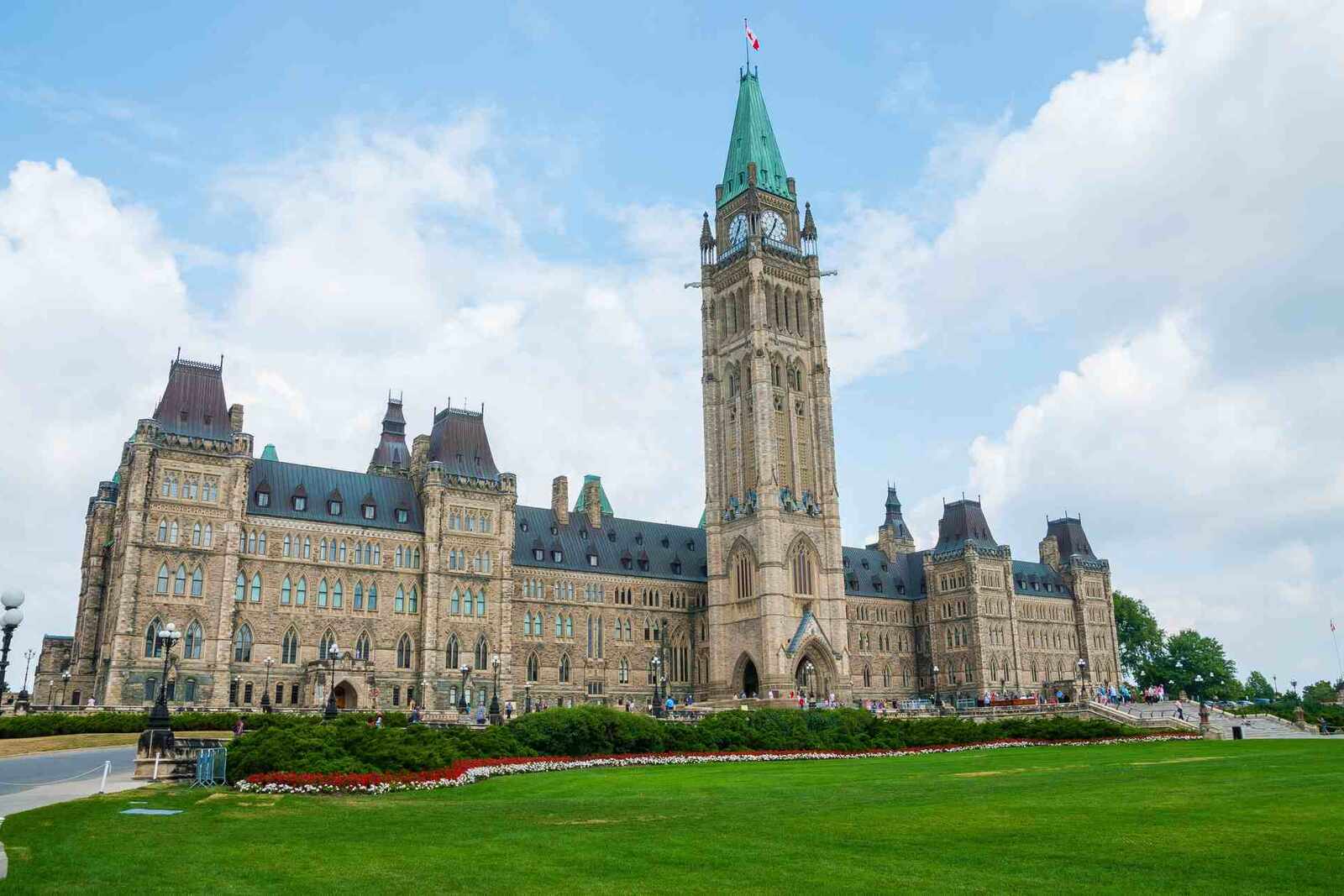 The Peace Tower and Centre Block of Canada's Parliament Hill in Ottawa under a blue sky, standing in for Health Canada's federal regulatory authority