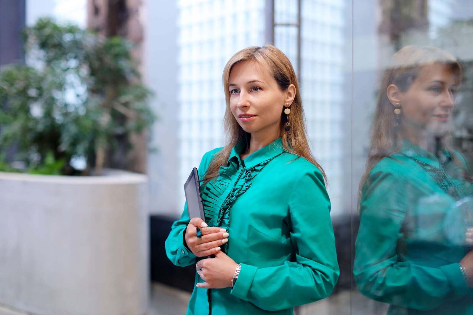 A professional holds a tablet while standing in a bright office atrium, standing in for FDA's electronic submission data-standards notice