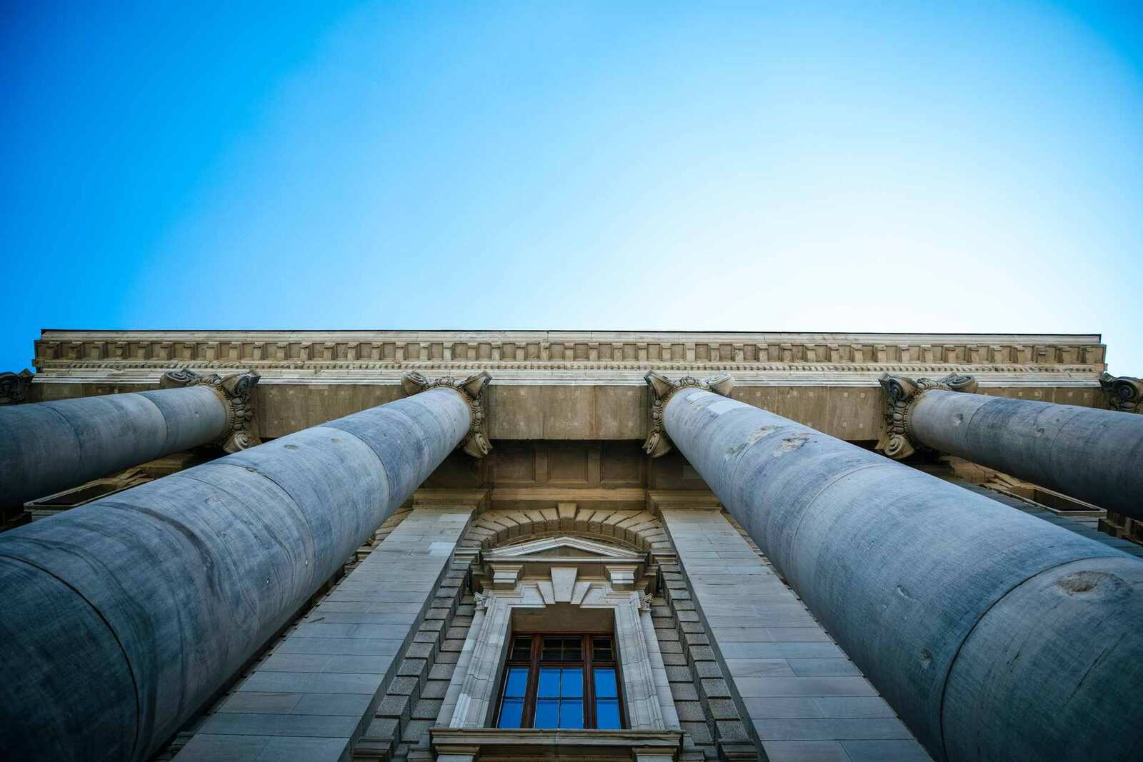 A classical government building's columns viewed from below against a clear blue sky, a generic federal-institutional stand-in — not FDA's own campus