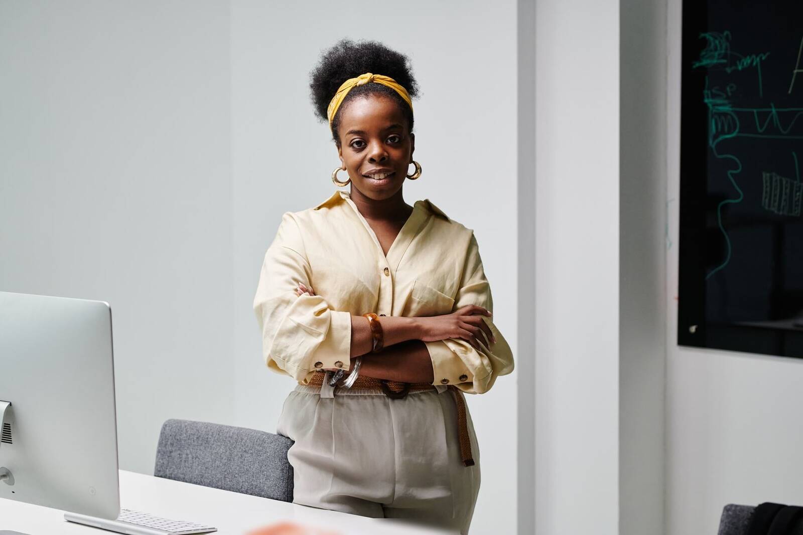 A confident professional in a bright office with a data chart on a screen behind them, a generic stand-in for regulatory and quality review