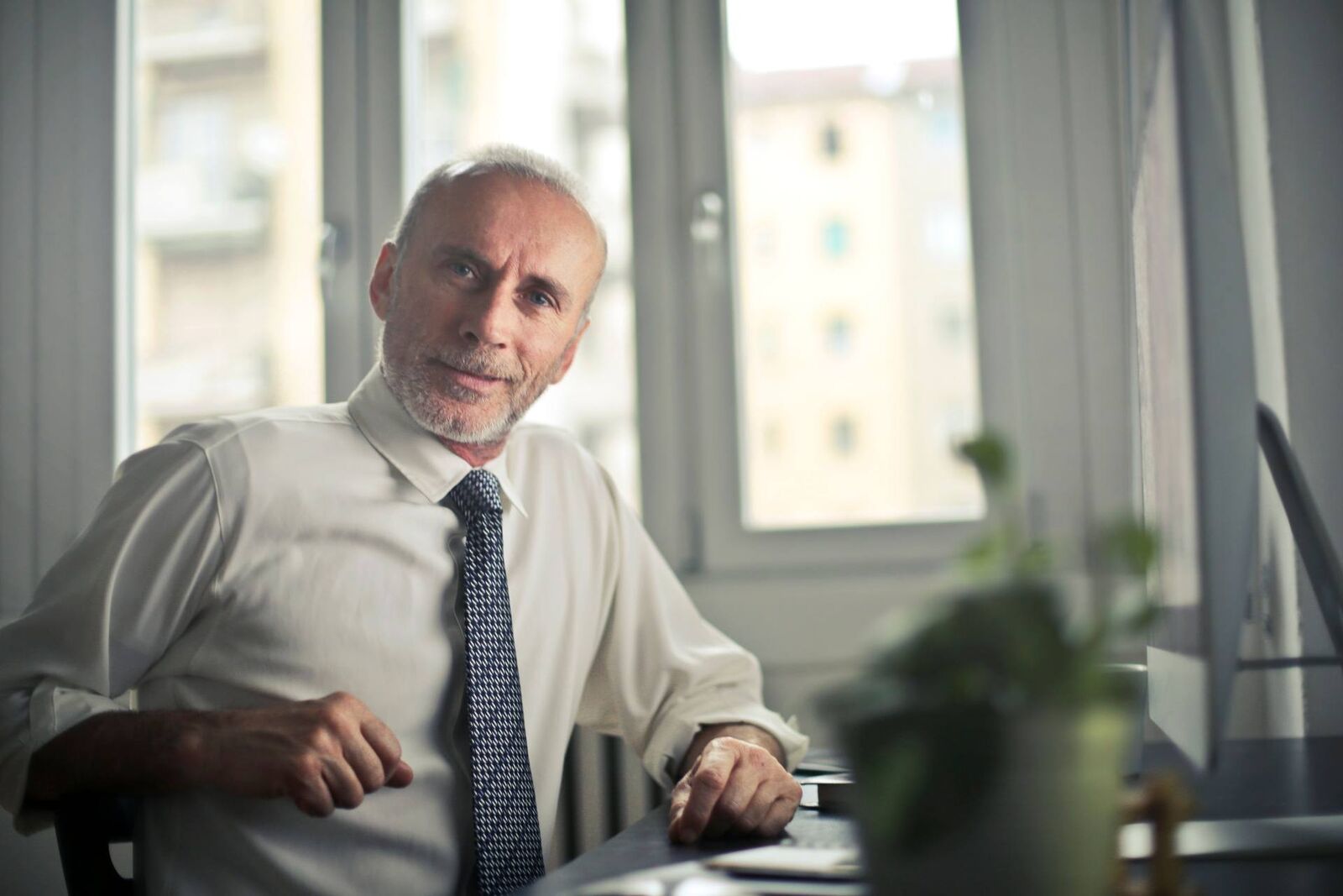 A senior pharmaceutical executive in an office setting, a generic stand-in for GSK leadership announcing the approval