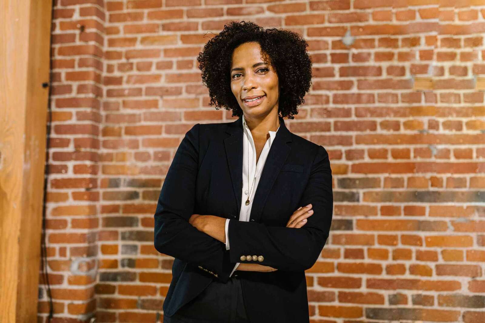 A confident executive with arms crossed against a brick wall, a generic stand-in for a company's first regulatory approval