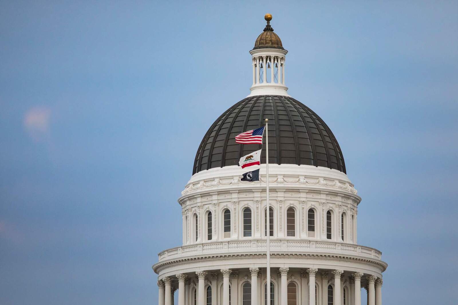 A state capitol building's dome under a blue sky, representing government regulatory action