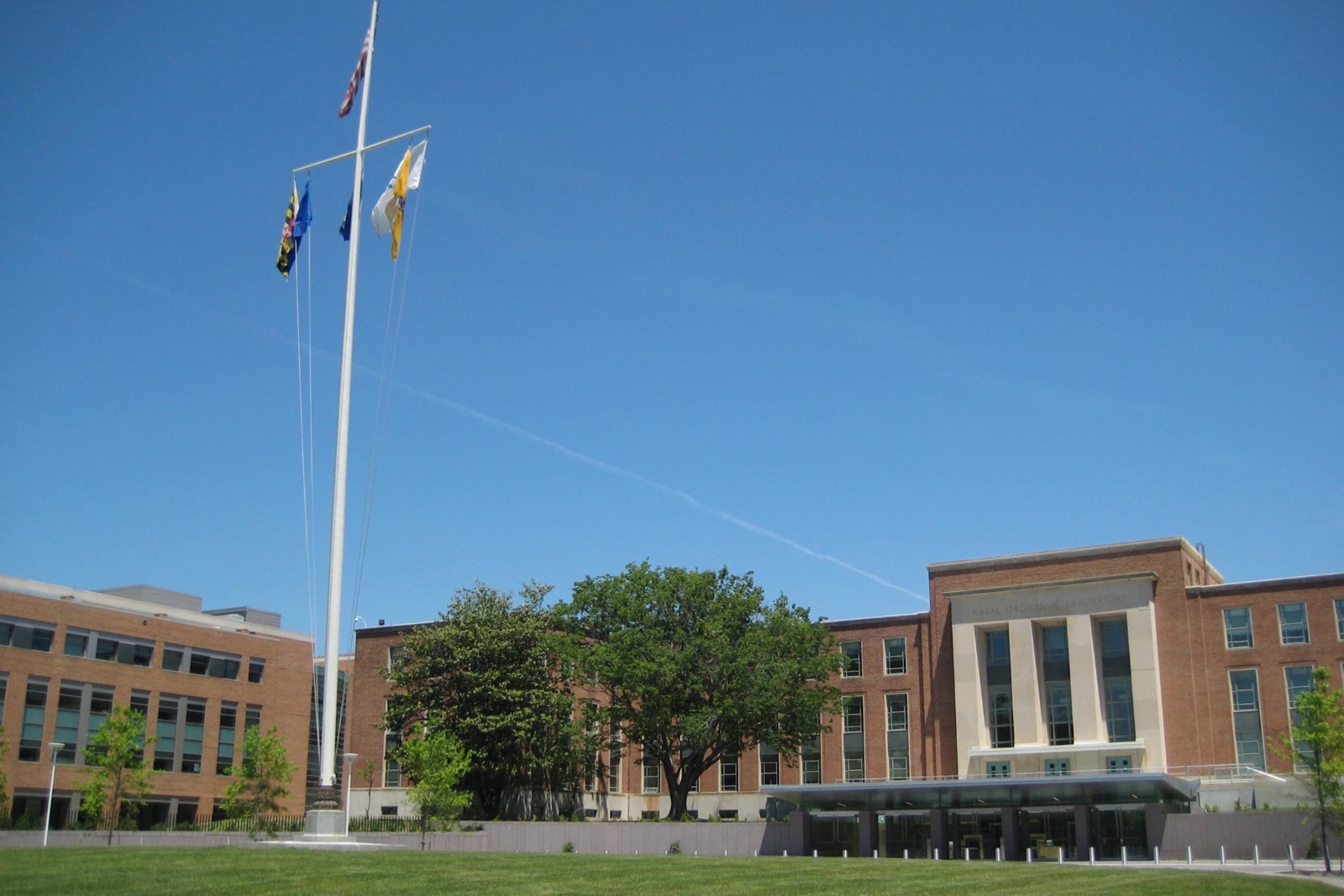 Buildings 1 and 21 at the entrance to the FDA's White Oak campus, with the Maryland and agency flags flying