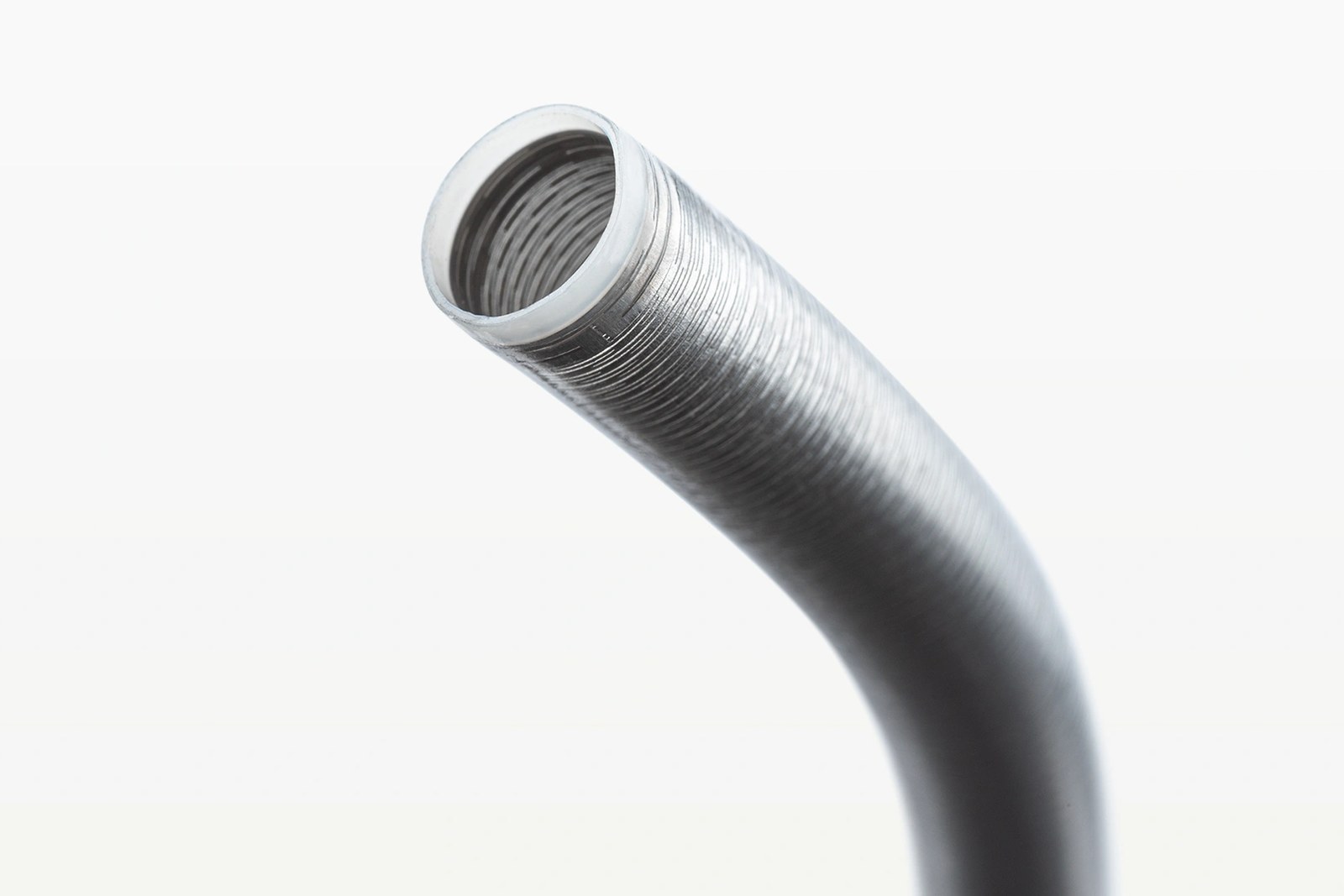 Close-up of the stainless steel tip of Penumbra's Lightning Flash aspiration catheter, part of its Lightning computer assisted vacuum thrombectomy (CAVT) technology, against a white background