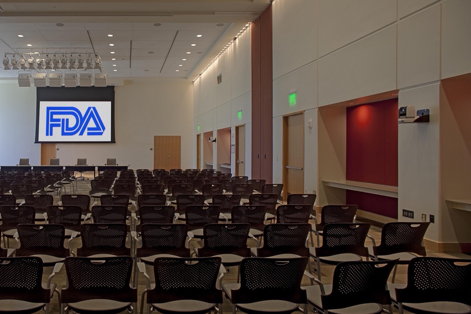 Rows of empty seats facing an FDA-branded screen in the White Oak Great Room