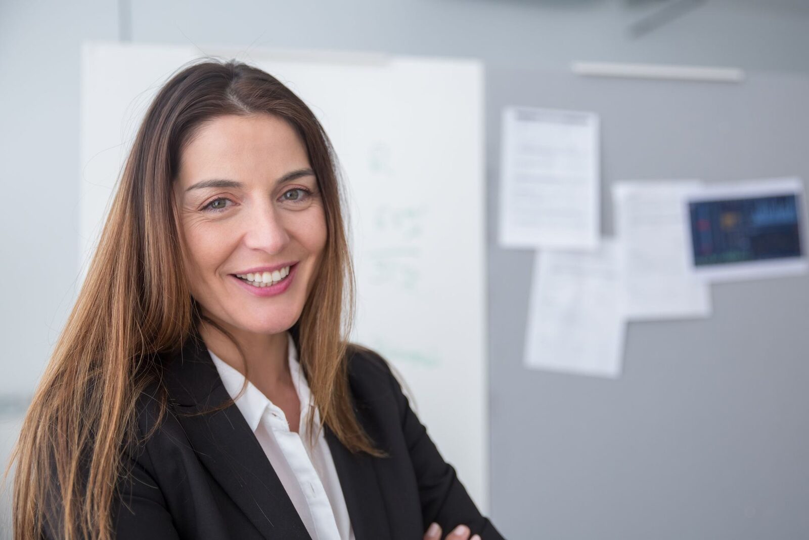 A professional smiles in a research-office portrait, standing in for the Soufflé Therapeutics team marking its Series B close