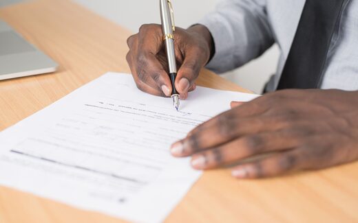 Hands signing a document with a fountain pen, a generic stand-in for the close of Altay Therapeutics' Series A