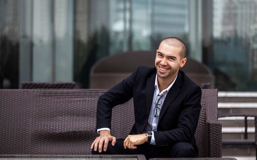 A smiling executive in a dark suit on an office terrace, a generic stand-in for Novo Nordisk leadership
