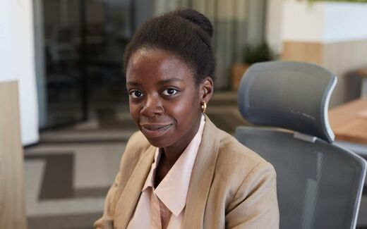 A businesswoman seated in an office chair, a generic company-leadership stand-in for Eko Health