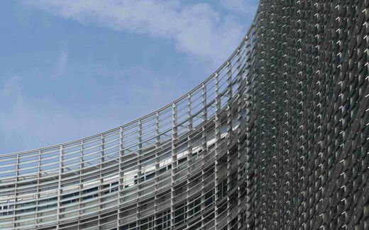 A close-up of a curved EU institutional building facade against a blue sky, a generic stand-in for EU regulatory policy