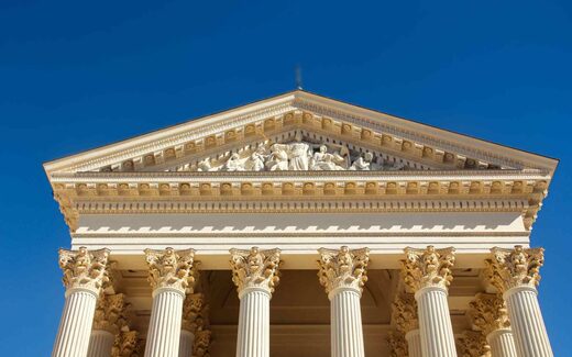 A classical government building’s pediment and columns against a clear blue sky, a generic stand-in for FDA’s regulatory authority
