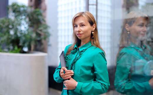 A professional holds a tablet while standing in a bright office atrium, standing in for FDA's electronic submission data-standards notice