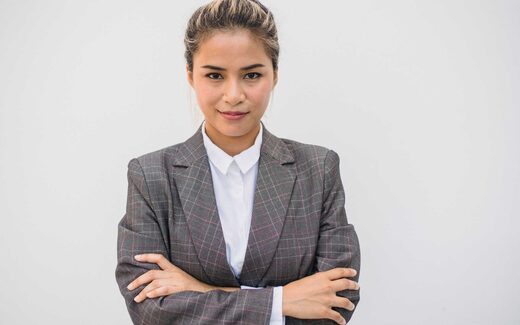 A corporate executive with arms crossed in a studio portrait, a generic stand-in for Olympus leadership