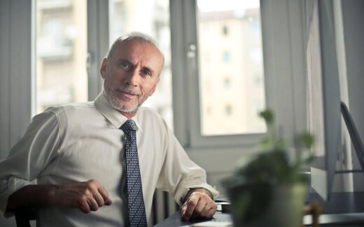 A senior pharmaceutical executive in an office setting, a generic stand-in for GSK leadership announcing the approval