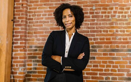A confident executive with arms crossed against a brick wall, a generic stand-in for a company's first regulatory approval