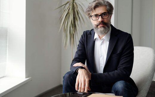 A seated executive in an office, a generic stand-in for NeuroXT's announcement