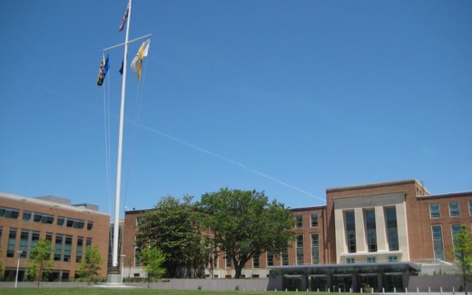 Buildings 1 and 21 at the entrance to the FDA's White Oak campus, with the Maryland and agency flags flying