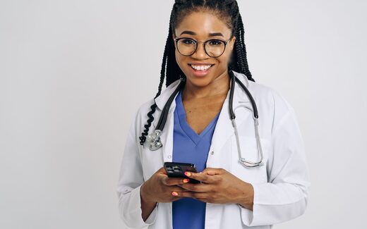 A physician in a white coat with a stethoscope, a generic stand-in for a vascular surgeon or interventional radiologist