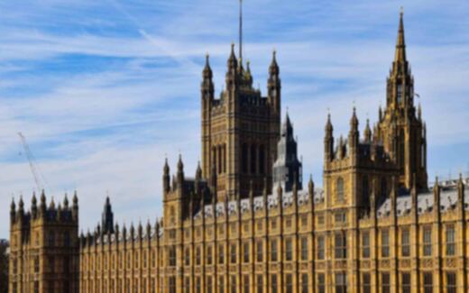 The Houses of Parliament and Victoria Tower in Westminster, London, under a blue sky