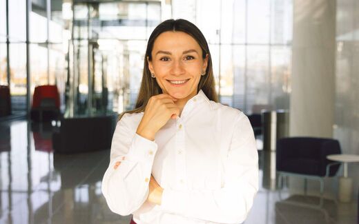 A smiling executive in a bright office lobby, a generic stand-in for AbbVie leadership announcing the approval