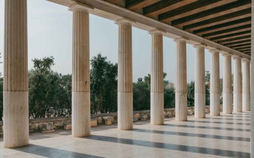 A sunlit colonnade of classical columns, used as a generic regulatory-decision backdrop