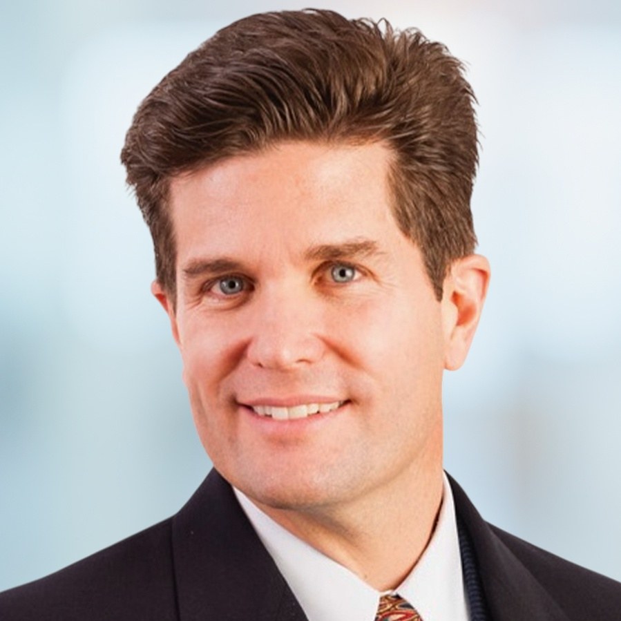 Kenneth Schultz, MD, Chairman, Chief Executive Officer and President of Trethera Corporation, in a dark suit and patterned tie