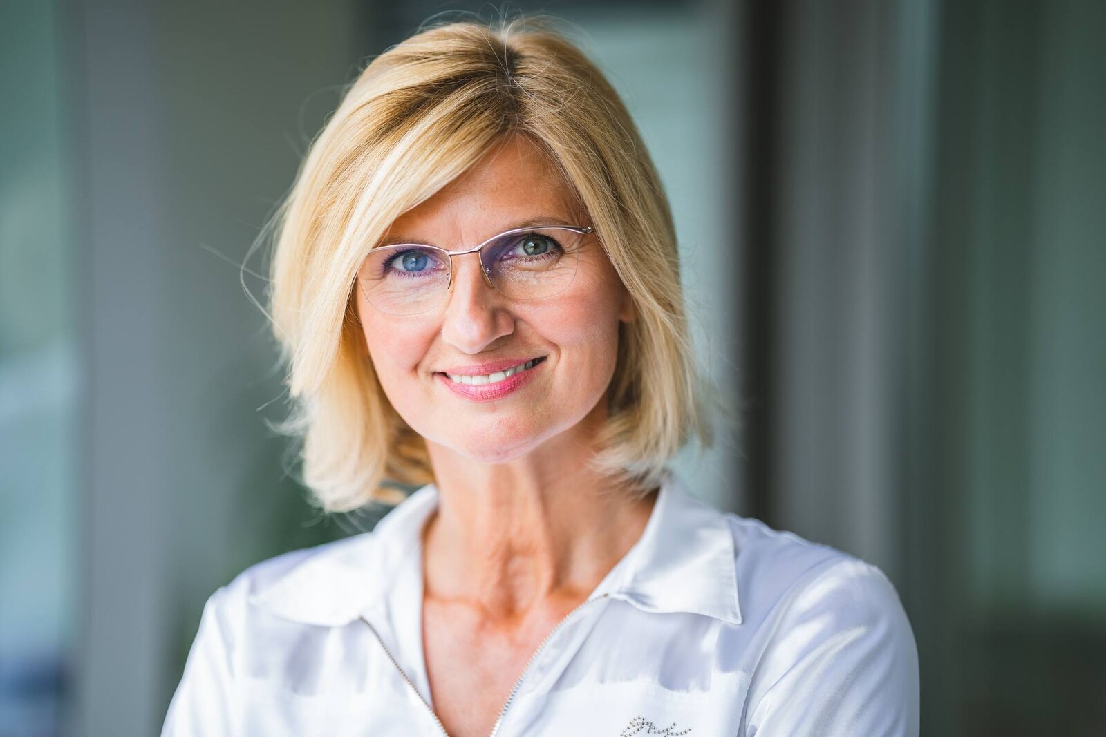 A physician in professional attire in a clinical office setting