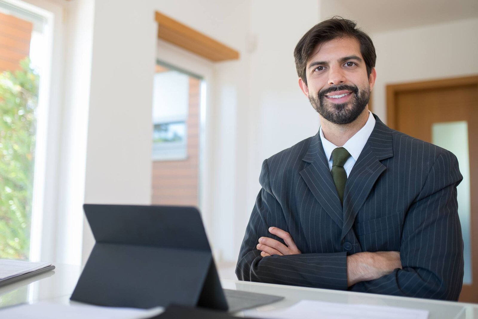 A pharmaceutical executive in a bright office, standing in for UCB's autoinjector approval announcement